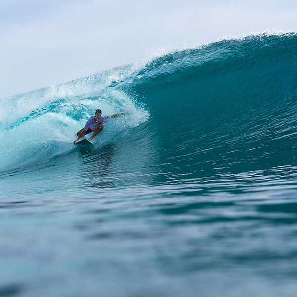World class surf spot G-Land with surfer riding a barrel point break