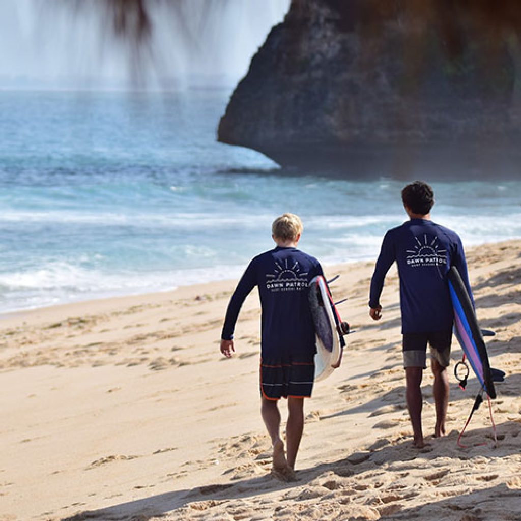 surfing in bali for beginners walking on beach surfing in bali for beginners walking on beach
